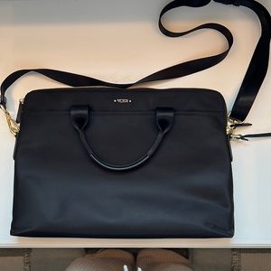 Tumi laptop bag. Never used. Black with gold zipper.
